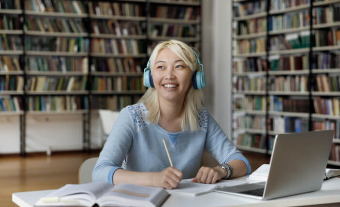 A happy student in an ESL program writing an essay