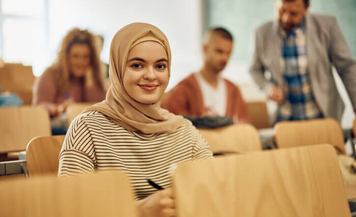 private school in Toronto A fast-track university prep school graduate sitting in a university class waiting for class to begin.