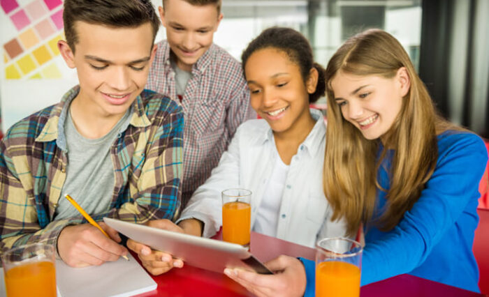 ESL Program A group of smiling students studying together at our ESL school