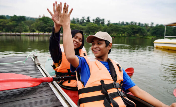 A pair of summer camp participants canoeing
