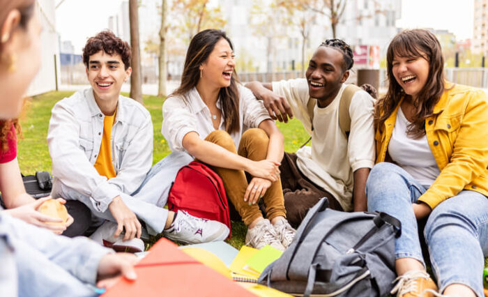 private school A group of private school students socializing on a summer day on the grass