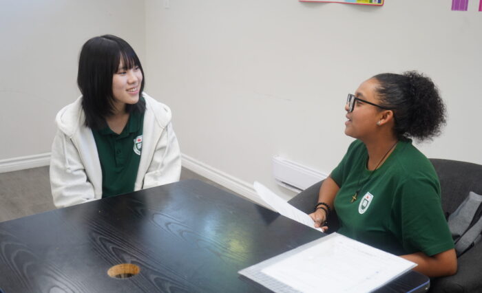 Students from different cultures helping each other in a Canadian high school.